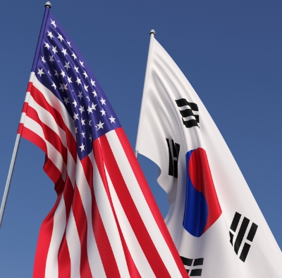 Light-rippled background containing the article title surrounded by American and Korean flags.